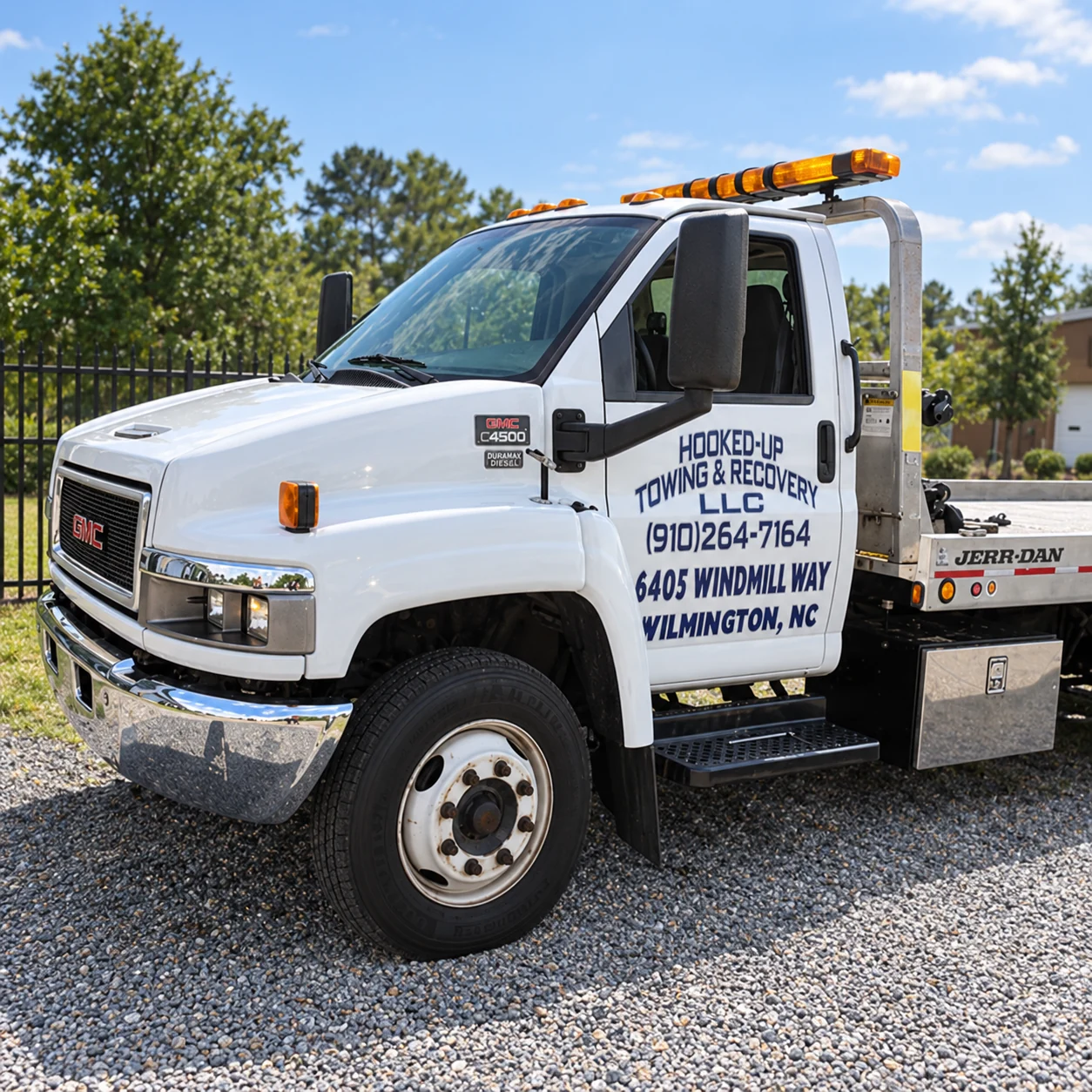 White Hooked-Up Towing and Recovery flatbed truck